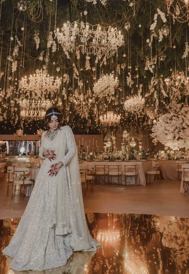 Novia en salón de bodas con muchos candelabros